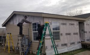 Man installing siding. 